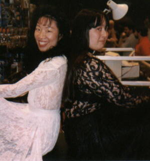 Me in a black dress, with another convention-goer in a white dress